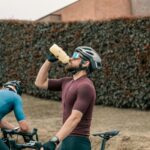 Cyclist drinking performance drink from a bidon